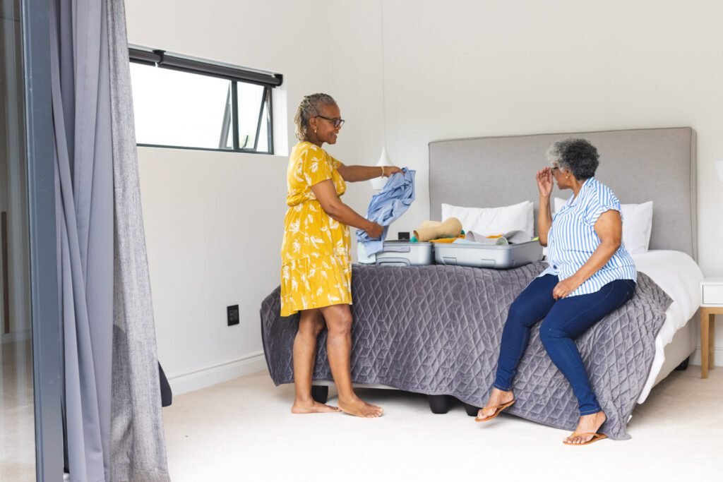 Two older women in ADU, one unpacking a suitcase